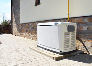  Natural gas backup generator set up along the wall of the house