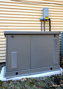 Residential Generator On Concrete Pad, Next To A House Wall